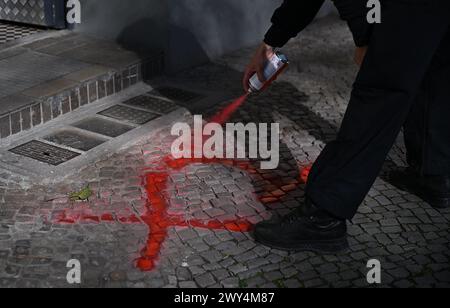 Berlin, Deutschland. April 2024. Ein Polizist markiert den Eingang zu einem Haus, das bereits mit Farbe evakuiert wurde, bevor eine Bombe aus dem Zweiten Weltkrieg entschärft wurde. Quelle: Britta Pedersen/dpa/Alamy Live News Stockfoto