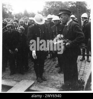 ZEREMONIELLE BEERDIGUNG DER BRÜSSELER POLIZEI, ERSCHOSSEN VON DEN DEUTSCHEN - belgische Polizisten, die Blumen in die Gräber werfen, britische Armee, 21. Armeegruppe Stockfoto