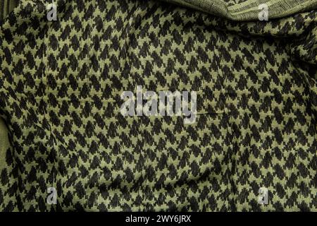 Keffieh Schal. Die Textur des traditionellen Baumwoll-symbolischen arabischen Schals. Khaki Hintergrund. Stockfoto