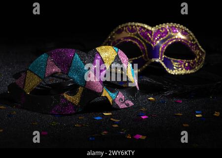 Karnevalsparty. Venezianische Maskerade-Masken auf schwarzem Hintergrund. Stockfoto