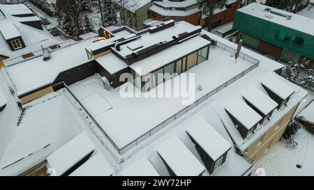 Drohnenfotografie von der Dachterrasse, die während des schneebedeckten Winterabends von Schnee bedeckt ist Stockfoto