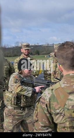 Fort Indiantown Gap, Pennsylvania, USA. April 2024. RANI DOUCETTE, ein Ausbilder der Pennsylvania National Guard's Individual Training Branch, gibt Soldaten Anweisungen, wie man eine M249 leichte Maschinenpistole abfeuern kann. (Kreditbild: © Kate Kramer/USA Army/ZUMA Press Wire) NUR REDAKTIONELLE VERWENDUNG! Nicht für kommerzielle ZWECKE! Stockfoto