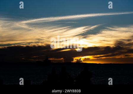 Salvador, Bahia, Brasilien - 13. April 2019: Touristen werden in Ponta de Humaita gesehen, die den dramatischen Sonnenuntergang in der Stadt Salvador, Bahia, genießen. Stockfoto