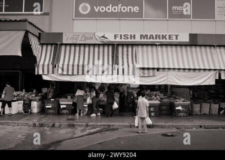 Ein Mann wartet auf der Straße vor einem Fischmarkt in Dutton Lane, Cabramatta, Western Sydney Stockfoto