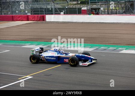 Ted Zorbas in Jacques Villeneuve's, 1997, Williams FW19 während der Demonstration zum 75. Jahrestag des Grand prix in Silverstone. Stockfoto