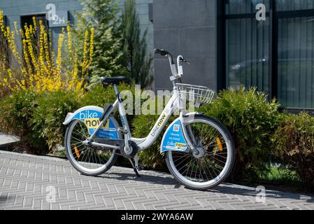 KIEW, UKRAINE - 05. April 2024. Urban Bike steht auf dem Bürgersteig. Bikenow. Ukrainischer Fahrradservice. Öffentliches Fahrrad auf dem Parkplatz. Pa Stockfoto