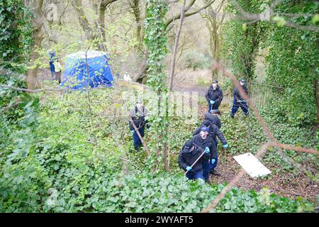 Polizeibeamte in einem forensischen Zelt in Kersal Dale, in der Nähe von Salford, Greater Manchester, wo eine große Untersuchung eingeleitet wurde, nachdem am Donnerstagabend menschliche Überreste gefunden wurden. Die Polizei von Greater Manchester (GMP) sagte, dass Beamte von einem Mitglied der Öffentlichkeit gerufen wurden, der einen „unbekannten Gegenstand in Plastik gewickelt“ fand. Bilddatum: Freitag, 5. April 2024. Stockfoto
