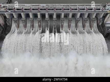 Fuzhou. April 2024. Eine Luftdrohne, die am 5. April 2024 aufgenommen wurde, zeigt, wie das Wasserkraftwerk Shuikou seine Schleusen für die Wasserableitung öffnet, weil die jüngsten Regenfälle am Oberlauf des Minjiang-Flusses in der südöstlichen Provinz Fujian stattgefunden haben. Quelle: Lin Shanchuan/Xinhua/Alamy Live News Stockfoto