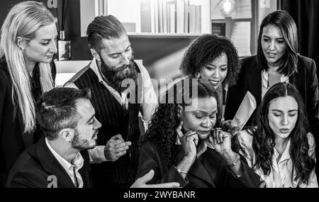 Druck auf eine zielgerichtete Geschäftsfrau während intensiver Teamdiskussion. Vielfältige Gruppe um nachdenkliche Kollegen in einer schwierigen Unternehmenssituation. Bl Stockfoto