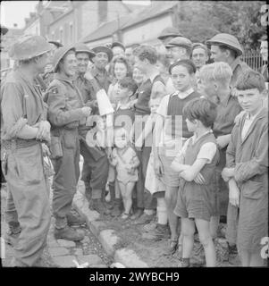 Männer der Green Howards der britischen Armee sprechen am 23. August 1944 mit französischen Zivilisten in der Normandie. Stockfoto
