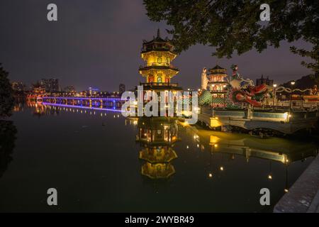 Eine bezaubernde nächtliche Landschaft mit Drachen- und Tiger-Pagoden und einer Brücke, die sich in einem stillen See spiegelt Stockfoto