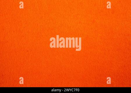 Textur aus Filz mit sichtbarer Faser und abstraktem Muster in orangefarbener Farbe Stockfoto