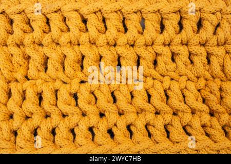 Orangefarbenes Baumwoll-Kordelmuster, abstrakter Texturhintergrund, weicher Fokus Stockfoto