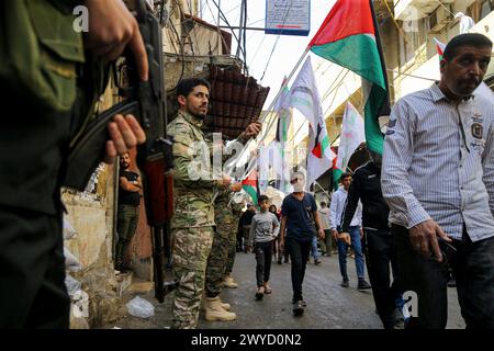 Beirut, Beirut, Libanon. April 2024. Palästinensische Flüchtlinge laufen unter palästinensischen Fahnen, die palästinensische Militanten während einer Zeremonie zum Internationalen Al-Quds-Tag im Flüchtlingslager Burj al-Barjneh in Beirut, die am letzten Freitag des heiligen Monats Ramadan stattfindet. Die Veranstaltung wurde 1979 im Iran, kurz nach der Islamischen Revolution, initiiert. (Kreditbild: © Marwan Naamani/ZUMA Press Wire) NUR REDAKTIONELLE VERWENDUNG! Nicht für kommerzielle ZWECKE! Stockfoto