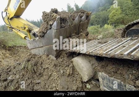 Bau eines Waldweges mit schwarzer Schlacke aus der Gießerei. Ormaiztegi, Guipúzcoa. Euskadi, Spanien. Stockfoto