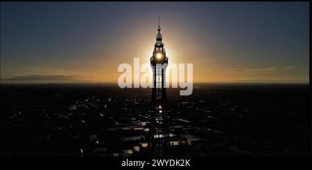 Ein Bild des Blackpool Tower bei Sonnenaufgang, das eine Silhouette der Blackpool Skyline mit der Sonne durch den Turm gibt. Stockfoto