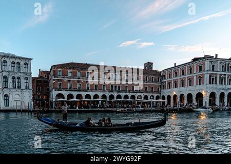 Venedig, Italien - 14. August 2023: Blick auf traditionelle Gondeln auf dem Canal Grande mit Gebäuden im Hintergrund Stockfoto