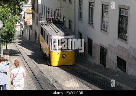 Der berühmte gelbe Trolley fährt durch die ältesten Viertel Lissabon, Portugal. Der gelbe Trolley ist bei Touristen sehr beliebt. Stockfoto