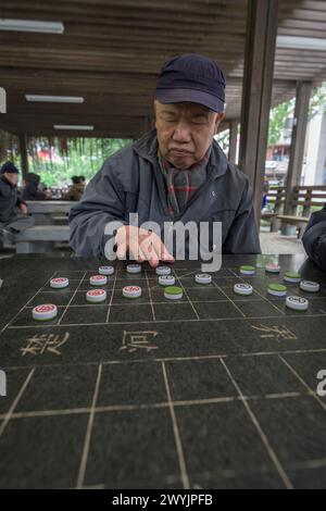 Senior-Männer konzentrierten sich stark auf ein strategisches Brettspiel Stockfoto