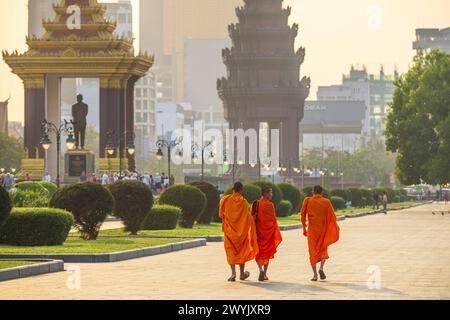 Kambodscha, Phnom Penh, Chamkar Mon District, buddhistische Mönche am Preah Suramarit Boulevard, das Unabhängigkeitsdenkmal und seine Majestät König Norodom Sihanouk Memorial im Hintergrund Stockfoto