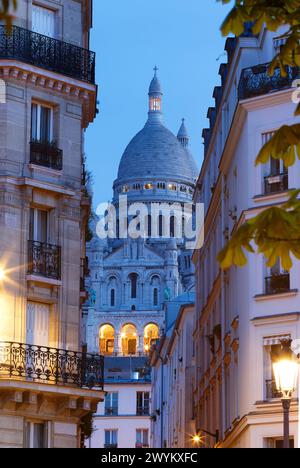 Die berühmte Sacre-coeur-Basilika zwischen haussmann-Gebäuden in Paris am Abend. Frankreich. Stockfoto