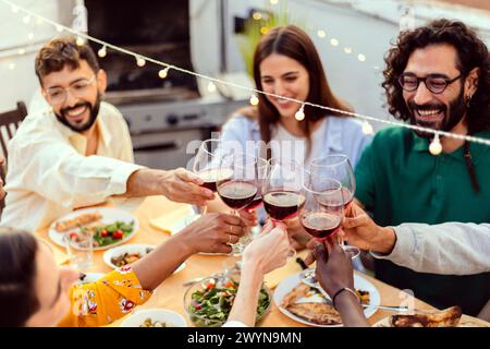 Gruppe von Freunden, die im Sommer Barbecue auf der Dachterrasse genießen Stockfoto