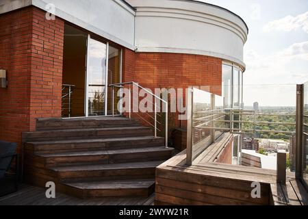 Ein Balkon mit einem atemberaubenden Blick auf die Skyline der Stadt, mit Wolkenkratzern, belebten Straßen und einer geschäftigen Metropole darunter Stockfoto