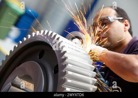 Arbeiter mit Schleifmaschine für Stück, Herstellung von Stahlgetrieben, Zahnrad, mechanische Industrie, Getriebewerk, Gipuzkoa, Baskenland, Spanien. Stockfoto