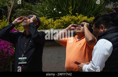 Menschen in Mexiko-Stadt beobachten die Sonnenfinsternis vom 8. April 2024 Stockfoto