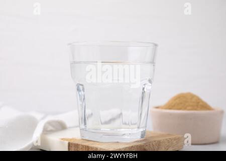 Ballaststoffe. Glas Wasser und Flohschalen-Pulver auf dem Tisch Stockfoto