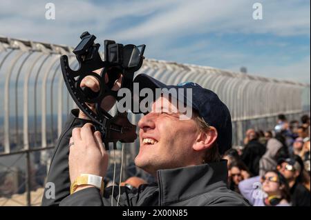 New York, New York, USA. April 2024. (NEU) Solar Eclipse 2024 in New York City. 8. April 2024, New York, New York, USA: David Souther verwendet einen Sextant, um die partielle Sonnenfinsternis von der Aussichtsplattform im 86. Stock des Empire State Building am 8. April 2024 in New York City zu betrachten. Mit der ersten Sonnenfinsternis, die seit sieben Jahren Nordamerika durchquerte, war New York City nicht auf dem Weg der Totalität, da nur 90 % der Sonne vom Mond bedeckt waren; die nächste Sonnenfinsternis, die in den Vereinigten Staaten zu sehen ist, wird 2044 sein. (Foto: M10s/TheNews2) (Foto: M10s/Thenews2/Zumapress) (Credit Image Stockfoto