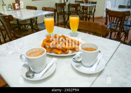 Ein typisches Frühstück: Churros, Kaffee und Orangensaft. Madrid, Spanien. Stockfoto