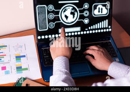 Man im Büro interagiert mit Daten aus dem globalen Unternehmensnetzwerk und lädt Daten sicher aus der Cloud hoch und herunter Stockfoto