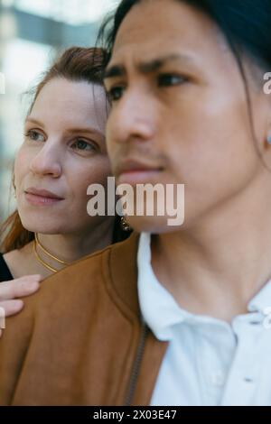 Porträt eines kontemplativen Paares aus der Nähe, das die urbane Landschaft tief genießt und die vielfältige Schönheit des Stadtlebens reflektiert. Stockfoto