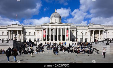 London, Großbritannien - 24. März 2024; Touristen ruhen sich auf den Stufen vor der National Gallery am Trafalgar Square aus Stockfoto