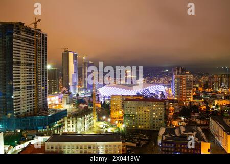 März 2022. Nachtansicht auf die Stadt Batumi, Georgia. Batumi Stadium, Adjarabet Arena. Stadtpanorama, Stadtbild. Nächtliche Stadtlichter. Stockfoto