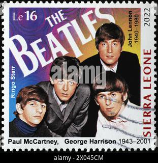 Die Beatles auf einer quadratischen Briefmarke Stockfoto