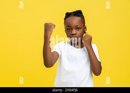 Gefährlicher, dunkelhäutiger kleiner Junge, der mit der Hand boxt Stockfoto