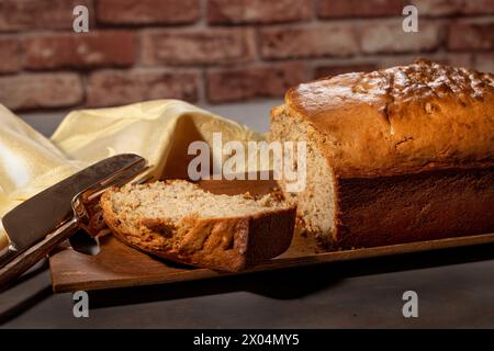 Bananenbrot, gebacken zu einer goldenen Kruste und auf ein Holzblech gelegt Stockfoto