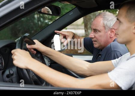 Leitender Fahrlehrer, der dem Schüler Anweisungen erteilt Stockfoto