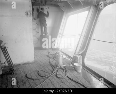 Die mobile Lackieranlage des Flugzeuges sprüht zwei Gallonen Farbe auf das Vierteldeck eines Flugzeugträgers im Cammell Lairds Yard, Birkenhead, 31. Oktober 1944. Stockfoto