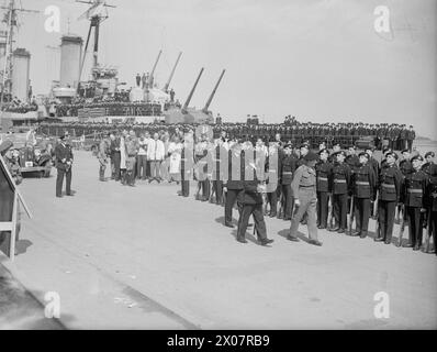 MONTGOMERY BEI DER BRITISCHEN MARINE IN KOPENHAGEN. 12. MAI 1945, KOPENHAGEN. WÄHREND DES BESUCHS VON FELDMARSCHALL MONTGOMERY ZU SCHIFFEN DER BRITISCHEN FLOTTE IN DER DÄNISCHEN HAUPTSTADT. - Feldmarschall Montgomery, Vizeadmiral R V Holt, Flaggenoffizier, Dänemark (dahinter), inspiziert die Königliche Marine-Ehrenwache. Im Hintergrund ist der Kreuzer HMS DIDO, mit hochgezogenen Waffen und ihren Schiffskompanie, die das Deck überquert Stockfoto