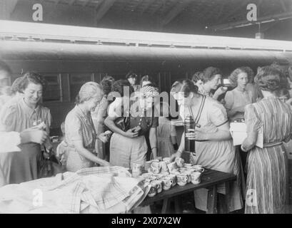 DER FERNE OSTEN: SINGAPUR, MALAYA UND HONGKONG 1939-1945 - die Japanische Kampagne und der Sieg 8. Dezember 1941 - 15. Februar 1942: Frauen und Kinder, die aus Penang, Malaya, evakuiert wurden, teilen sich während der Reise nach Singapur im Dezember 1941 einen Tee an einem Bahnhof Stockfoto