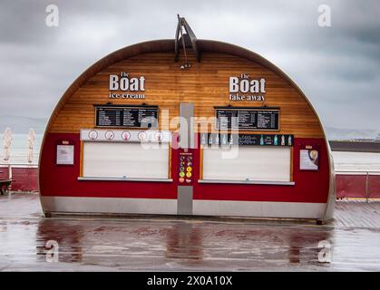 Das Boot zum Mitnehmen und die Eisdiele wurden Anfang April bei Wind und Regen geschlossen, bevor die Sommersaison auf Weymouth am Meer Dorset beginnt Stockfoto