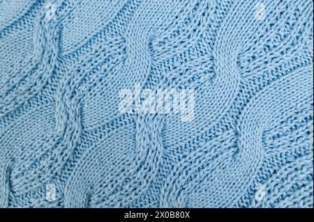 Hintergrund aus blauem Strickmaterial. Gestrickte Flechtstruktur. Stockfoto