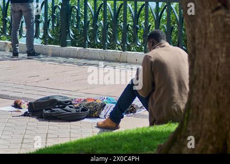 Tarragona, Spanien - 11. April 2024: Ein illegaler Straßenverkäufer verkauft seine Waren, die der städtischen Umwelt Farbe und Leben verleihen. Stockfoto