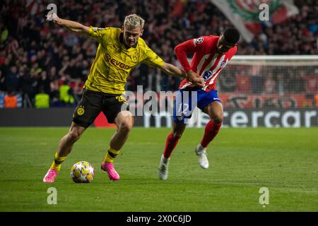 Borussia Dotmund-Spieler Julian Ryerson (L) kämpft mit Atletico de Madrid-Spieler Samuel Lino (R) im Viertelfinale der UEFA Champions League im Metropolitan Stadium in Madrid. Das erste Legspiel für das Viertelfinale der UEFA Champions League fand im Metropolitan Stadium in Madrid zwischen Atlético de Madrid und der Deutschen Borusia Dormund statt, wobei die lokale Mannschaft 2 Tore zu 1 erzielte und Rodrigo de Paul (4' ) erzielte und Samuel Lino (32') für den Geldautomaten und Sebastian Haller (81') für die Besucher. (Foto: David Canales/SOPA Images/SIPA USA) Stockfoto