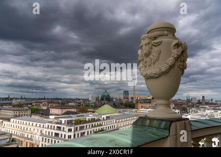 Einer der großen Krüge aus Sandstein mit Widderkopf auf dem Geländer der Aussichtsebene des Französischen Doms auf dem Gendarmenmarkt in Berlin-Mitte. Links vom Krug der Fernsehturm am Alexanderplatz, das Hotel Park inn und die Kuppel des Berliner Doms. *** Einer der großen Sandsteinkrüge mit Widderkopf auf dem Geländer der Aussichtsebene des Französischen Doms am Gendarmenmarkt im Zentrum Berlins links von der Kanne ist der Fernsehturm am Alexanderplatz, das Park inn Hotel und die Kuppel des Berliner Doms Stockfoto