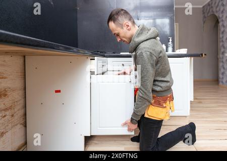 Ein älterer Mann zerlegt die Wohnküche außer Betrieb Stockfoto