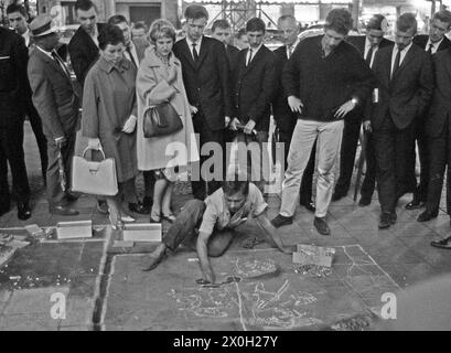 Die Menschen sehen ein Street Artist vor Café Kranzler auf dem Kurfürstendamm in Berlin. Stockfoto